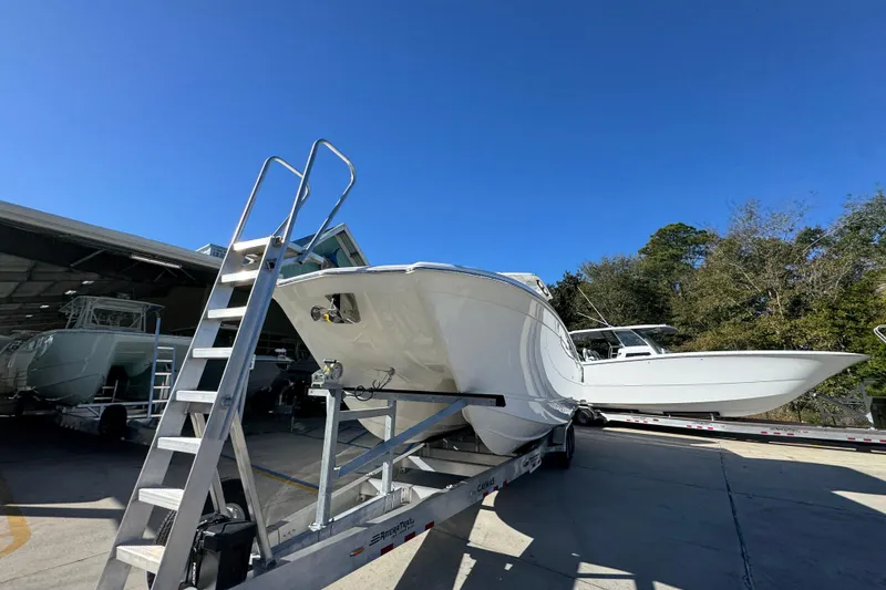 Slide: The Image of 2026 Caymas 34 CT boat on trailer under clear blue sky. - 5