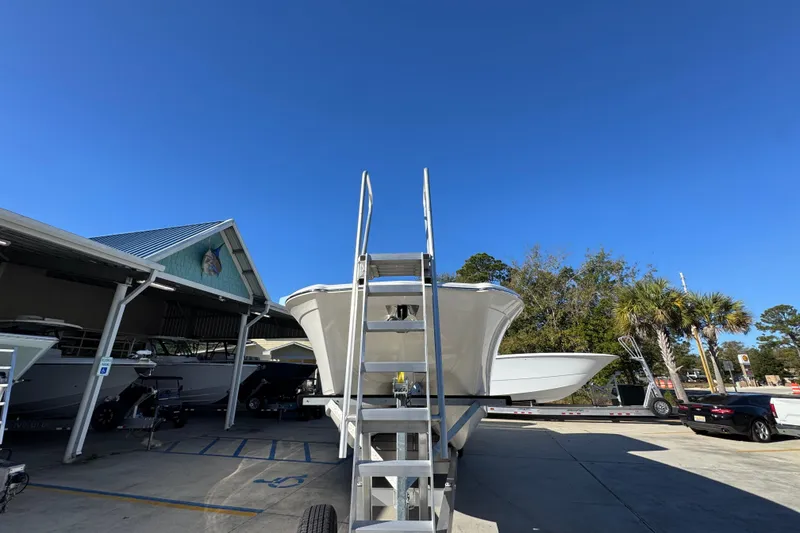 Slide: The Image of 2026 Caymas 34 CT boat on trailer under clear blue sky at marina. - 6