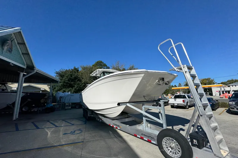 Slide: The Image of 2026 Caymas 34 CT boat on trailer under clear blue sky. - 7