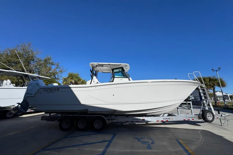 Slide: The Image of 2026 Caymas 34 CT boat on trailer under clear blue sky. - 9