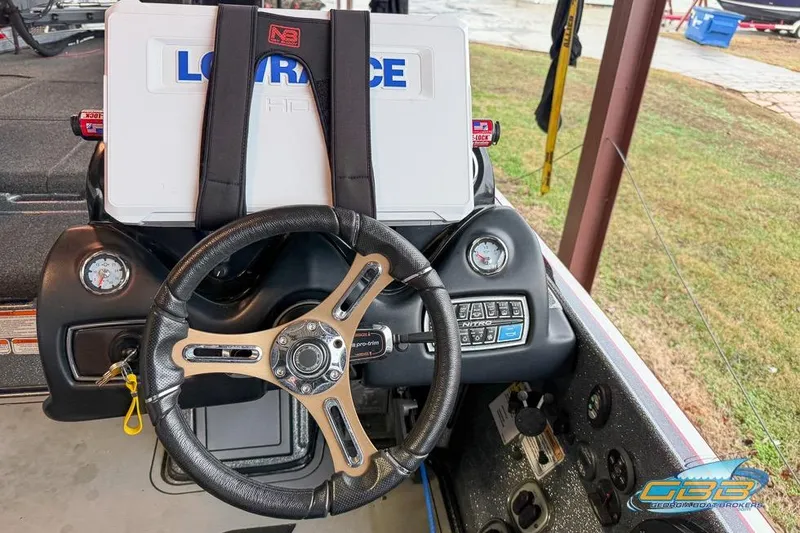 Slide: The Image of 2016 Nitro Z21 Pro boat dashboard with steering wheel and Lowrance HDS system. - 12