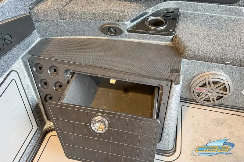 Slide: The Image of 2016 Nitro Z21 Pro boat storage compartment with cup holder and speaker. - 23