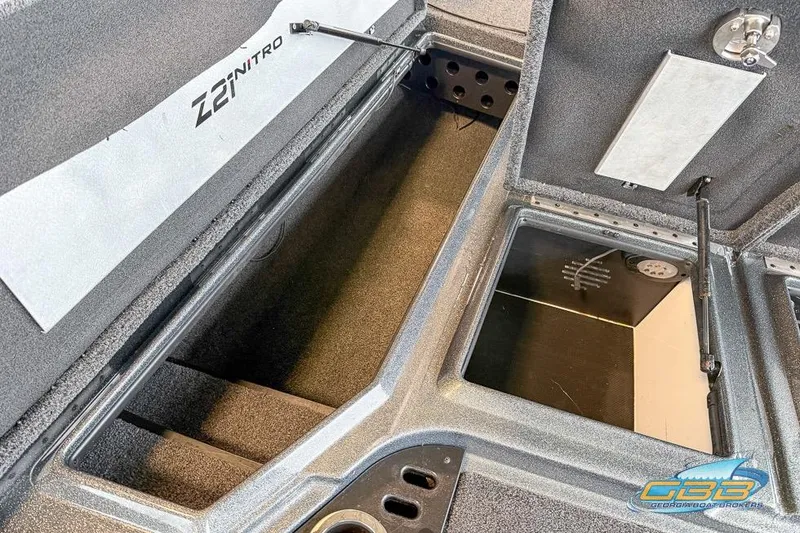 Slide: The Image of 2016 Nitro Z21 Pro boat storage compartments, open and empty, showcasing interior design. - 26