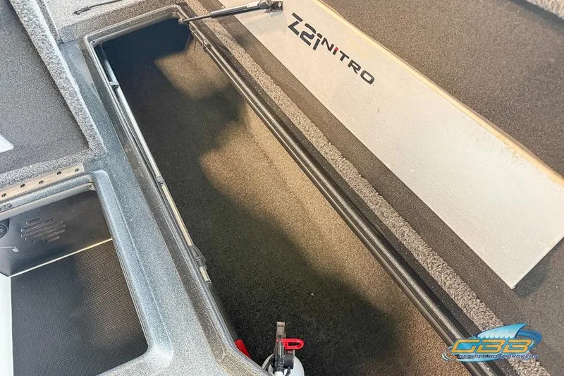 Slide: The Image of 2016 Nitro Z21 Pro boat storage compartment, open and empty, with visible branding. - 27