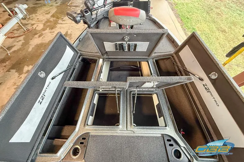 Slide: The Image of 2016 Nitro Z21 Pro boat interior with open storage compartments and control panel. - 28