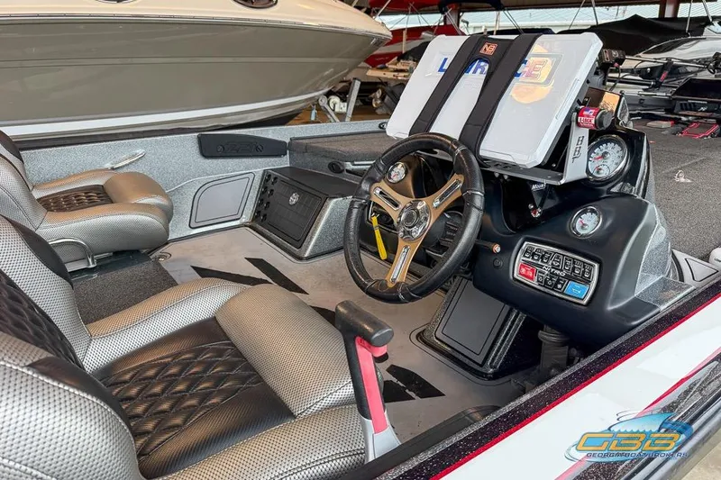 Slide: The Image of Interior of a 2016 Nitro Z21 Pro boat with steering wheel and control panel. - 38