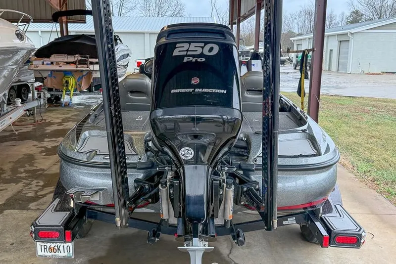 Slide: The Image of 2016 Nitro Z21 Pro boat with 250 Pro engine in a storage area. - 48