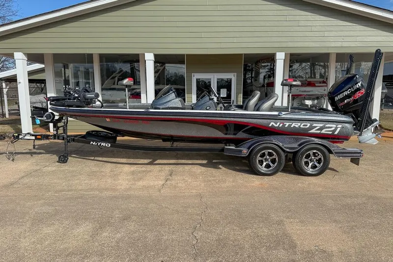 Slide: The Image of 2016 Nitro Z21 Pro bass boat with Mercury engine, parked on a trailer. - 8