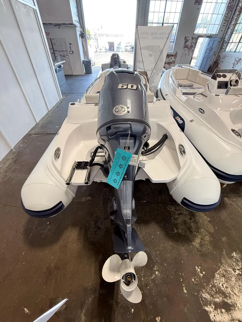 Slide: The Image of 2024 AB Inflatables Nautilus 13 DLX boat with 60 HP engine in showroom. - 3