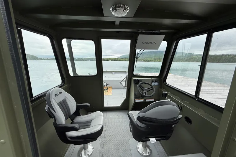 Slide: The Image of Interior of 2026 SeaArk 2672 CUB boat with two seats and Garmin navigation. - 3