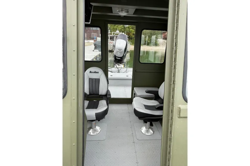 Slide: The Image of Interior view of 2026 SeaArk 2672 CUB boat with seating and outboard motor. - 4
