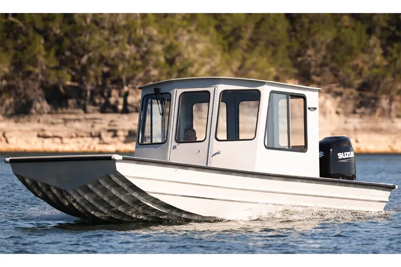 Slide: The Image of Manufacturer Provided Image: 2026 SeaArk 2672 CUB boat cruising on a lake with scenic background. - 6
