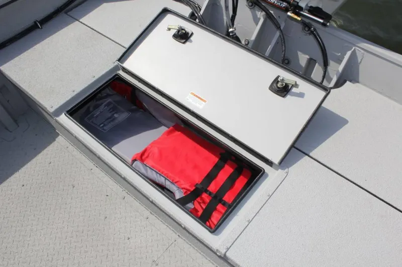 Slide: The Image of Storage compartment on 2026 SeaArk 2672 CUB boat with life jackets inside. - 8