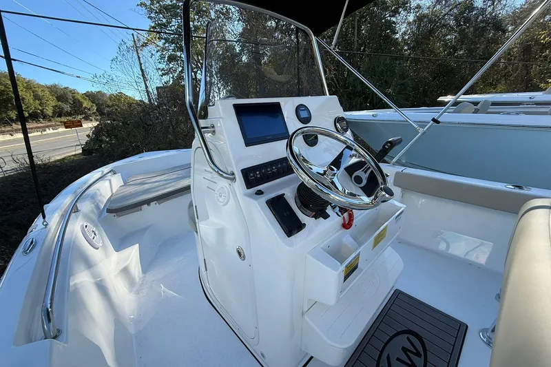Slide: The Image of 2026 Key West 189 FS boat interior with steering console and seating. - 7