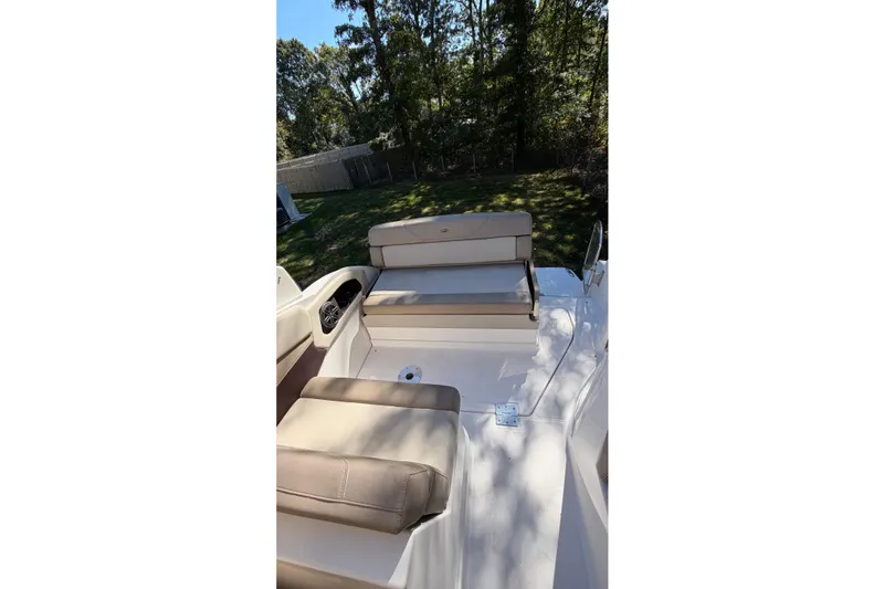 Slide: The Image of 2014 Regal 28 Express boat interior with beige seating and outdoor setting. - 13