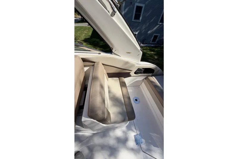 Slide: The Image of 2014 Regal 28 Express boat interior with beige seating and speaker. - 14