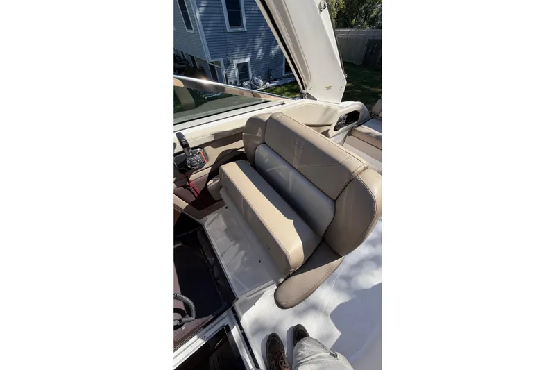 Slide: The Image of 2014 Regal 28 Express boat interior with beige seating and control panel. - 16