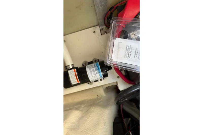 Slide: The Image of 2014 Regal 28 Express boat interior showing mechanical components and wiring. - 25