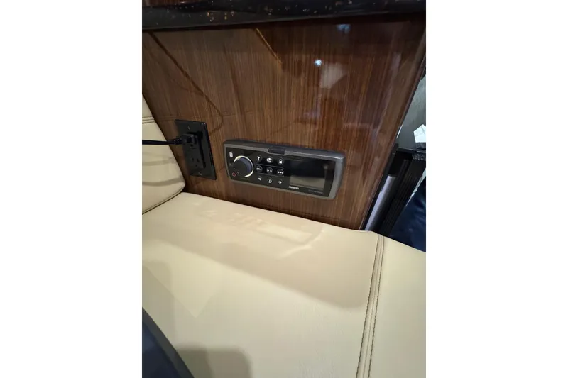 Slide: The Image of 2014 Regal 28 Express interior with wood paneling and control panel. - 28