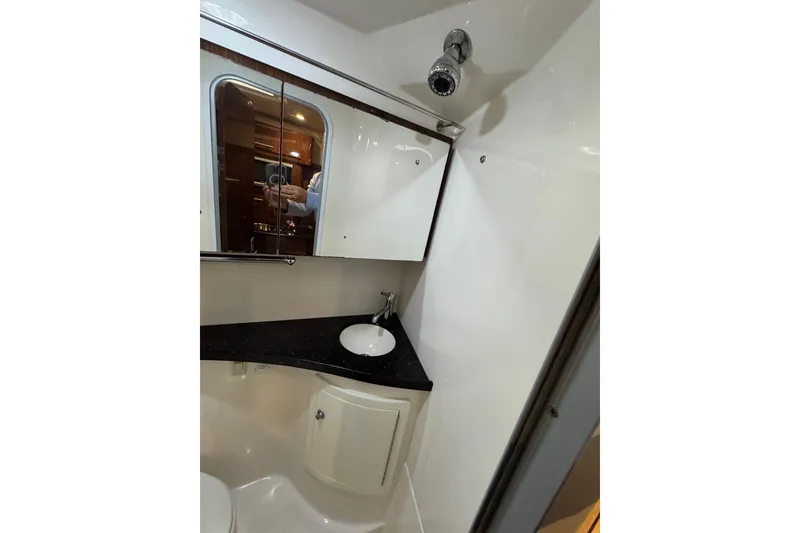 Slide: The Image of 2014 Regal 28 Express bathroom with sink, mirror, and storage cabinet. - 29