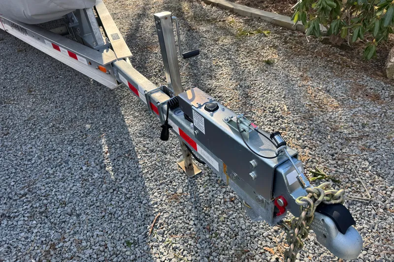 Slide: The Image of Trailer hitch of a 2014 Regal 28 Express boat on gravel surface. - 37