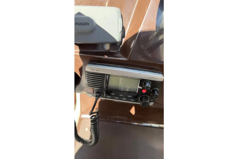 Slide: The Image of VHF radio on 2014 Regal 28 Express boat dashboard. - 9