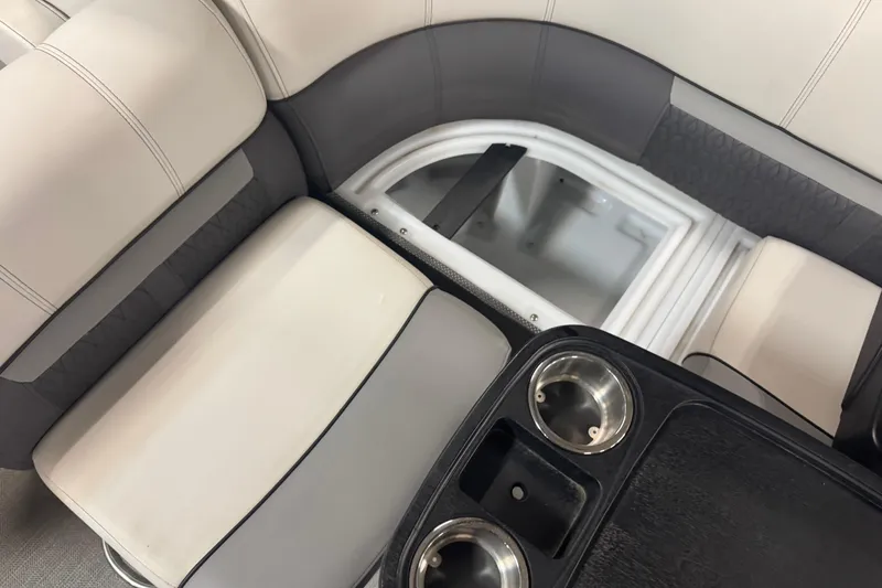 Slide: The Image of 2021 Godfrey Sweetwater 2386 FS boat seating with storage compartment and cup holders. - 10