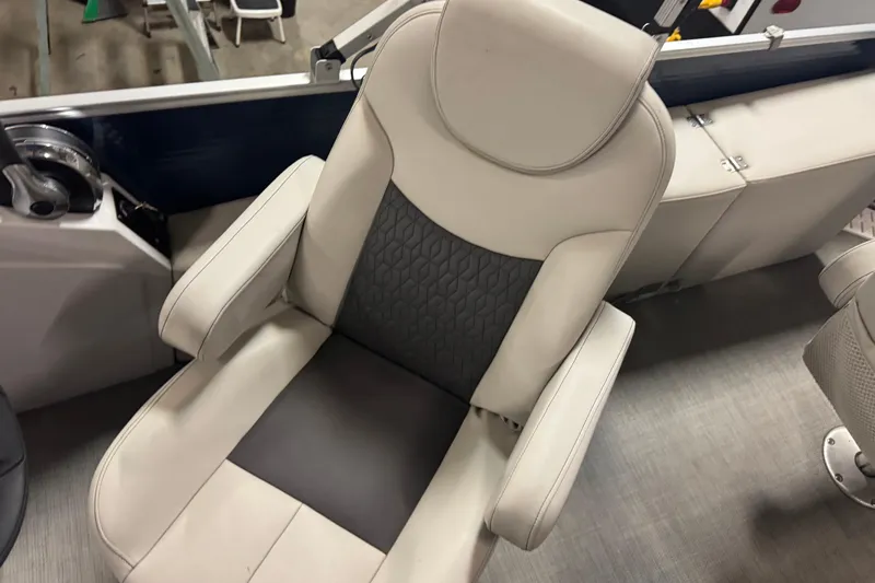 Slide: The Image of Captain's chair on 2021 Godfrey Sweetwater 2386 FS boat, featuring gray and beige upholstery. - 15