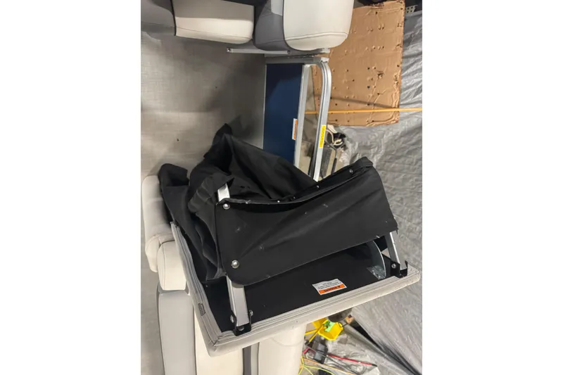 Slide: The Image of 2021 Godfrey Sweetwater 2386 FS boat interior with folded black canopy and seating. - 21