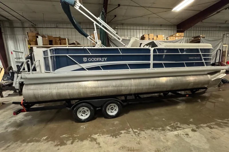 Slide: The Image of 2021 Godfrey Sweetwater 2386 FS pontoon boat in a warehouse setting. - 3