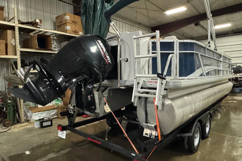 Slide: The Image of 2021 Godfrey Sweetwater 2386 FS pontoon boat with Mercury outboard motor in a garage. - 4