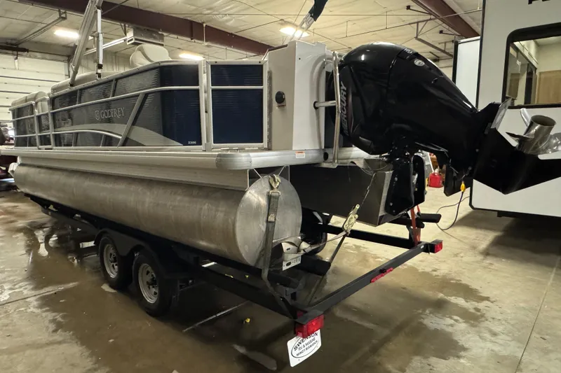 Slide: The Image of 2021 Godfrey Sweetwater 2386 FS pontoon boat on trailer in indoor storage. - 5