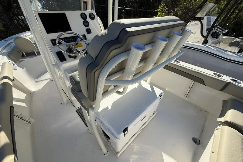 Slide: The Image of 2026 Key West 219 FS boat interior with steering console and rod holders. - 11