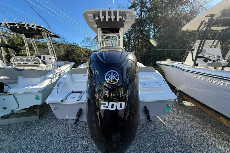 Slide: The Image of 2026 Key West 219 FS boat with 200 horsepower engine displayed outdoors. - 2