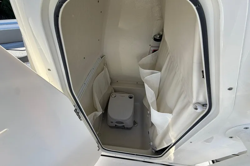 Slide: The Image of Interior of 2026 Key West 219 FS boat with compact marine toilet. - 6