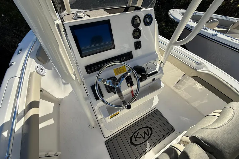 Slide: The Image of 2026 Key West 219 FS boat console with steering wheel and navigation display. - 7