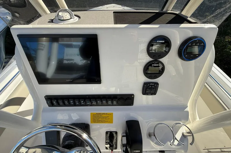 Slide: The Image of 2026 Key West 219 FS boat dashboard with Garmin display and Yamaha gauges. - 8