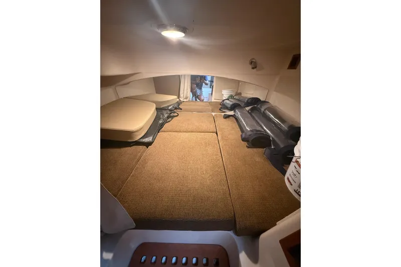 Slide: The Image of 2013 Grady-White Express 330 cabin interior with cushions and storage. - 11