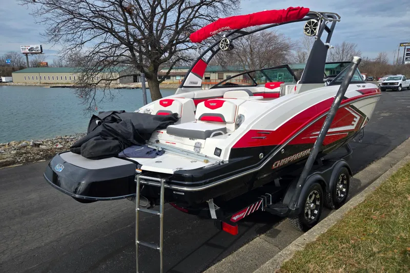 Slide: The Image of 2015 Chaparral Vortex 223 VRX boat on trailer by a lakeside road. - 1