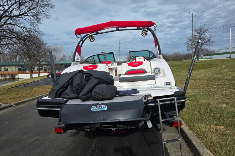 Slide: The Image of 2015 Chaparral Vortex 223 VRX boat with red accents, parked on a trailer. - 2