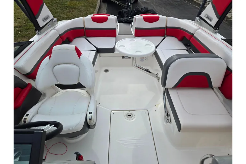 Slide: The Image of 2015 Chaparral Vortex 223 VRX boat interior with red and white seating and a round table. - 24