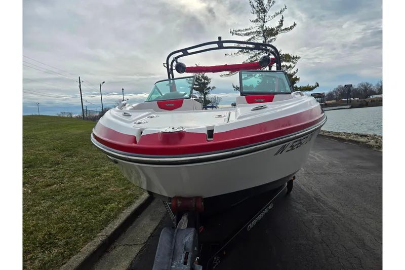 Slide: The Image of 2015 Chaparral Vortex 223 VRX boat on trailer by lakeside, overcast sky. - 6