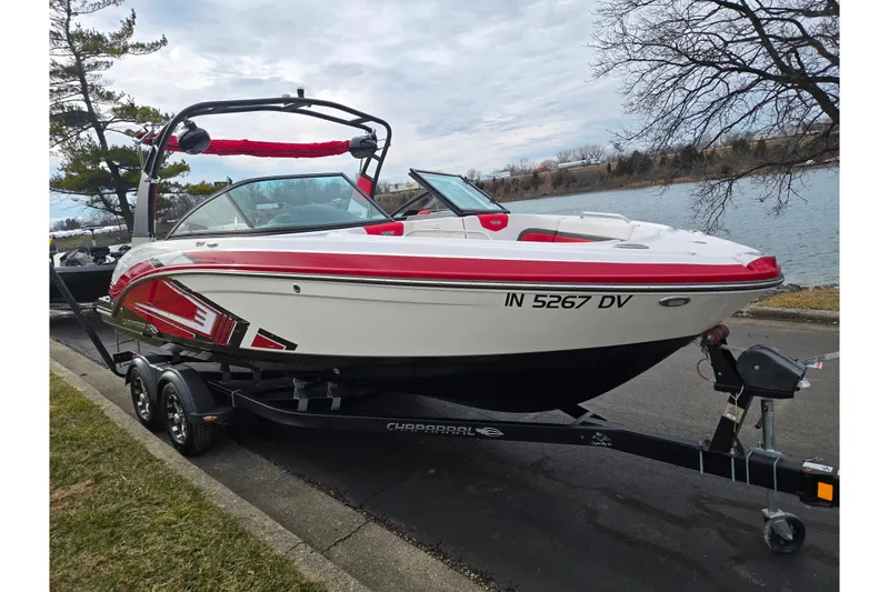 Slide: The Image of 2015 Chaparral Vortex 223 VRX boat on trailer by a lakeside road. - 8