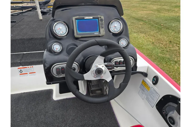 Slide: The Image of Steering console of a 2015 Nitro Z-7 boat with gauges and navigation system. - 11
