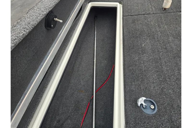 Slide: The Image of Open storage compartment in 2015 Nitro Z-7 boat, featuring carpeted interior and wiring. - 15