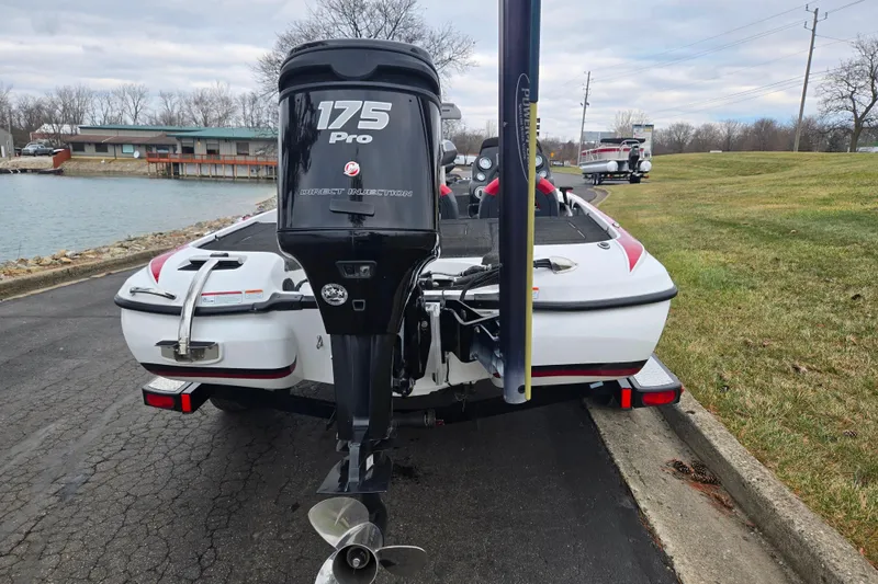 Slide: The Image of 2015 Nitro Z-7 boat with 175 Pro engine, parked near a lake. - 2