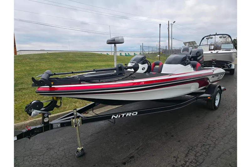 Slide: The Image of 2015 Nitro Z-7 boat on trailer, red and white design, parked outdoors. - 5