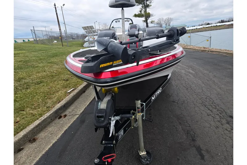 Slide: The Image of 2015 Nitro Z-7 boat with Minn Kota trolling motor on a paved road near water. - 6