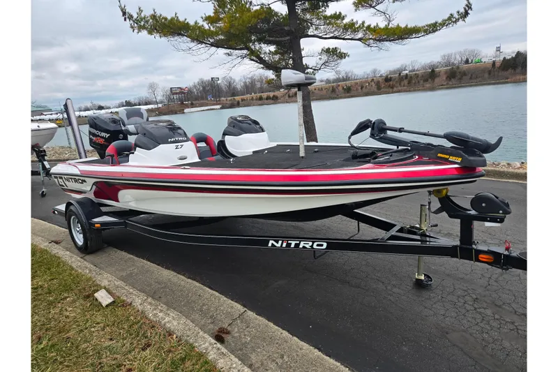 Slide: The Image of 2015 Nitro Z-7 boat on trailer by a lakeside, featuring sleek design and Mercury engine. - 8