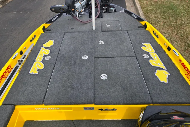 Slide: The Image of 2016 Bass Cat Caracal boat deck with gray carpet and yellow accents. - 15
